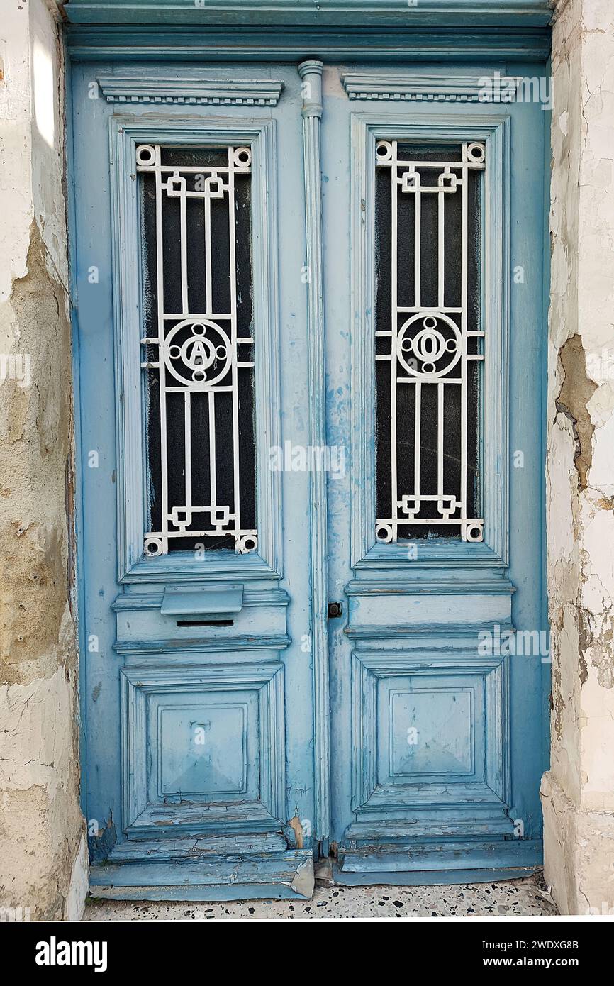 antique, double-leaf, blue entrance door with decor and glass. Stock Photo