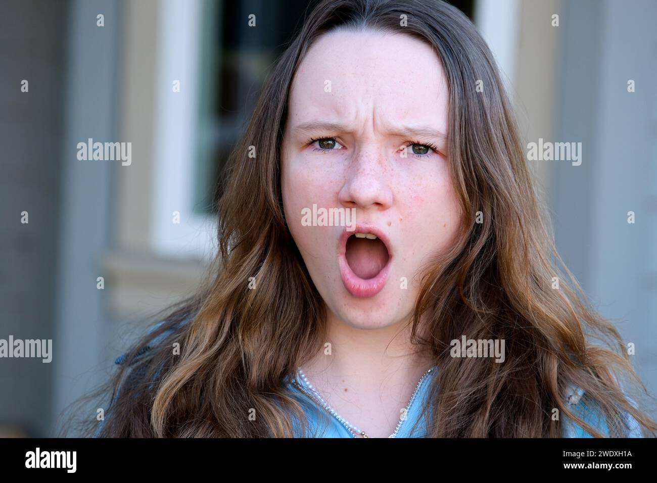 Young female showing emotion of shock, horror and surprise, on white background. UK . High quality photo Stock Photo