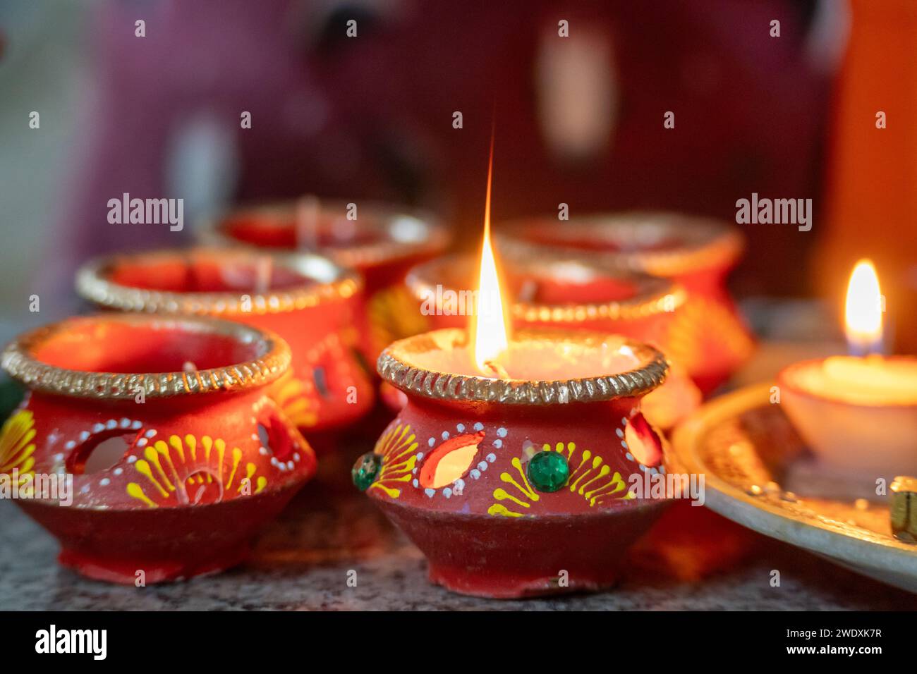 beautifully decorated diyas lit on the eve of diwali and the Ram temple ...