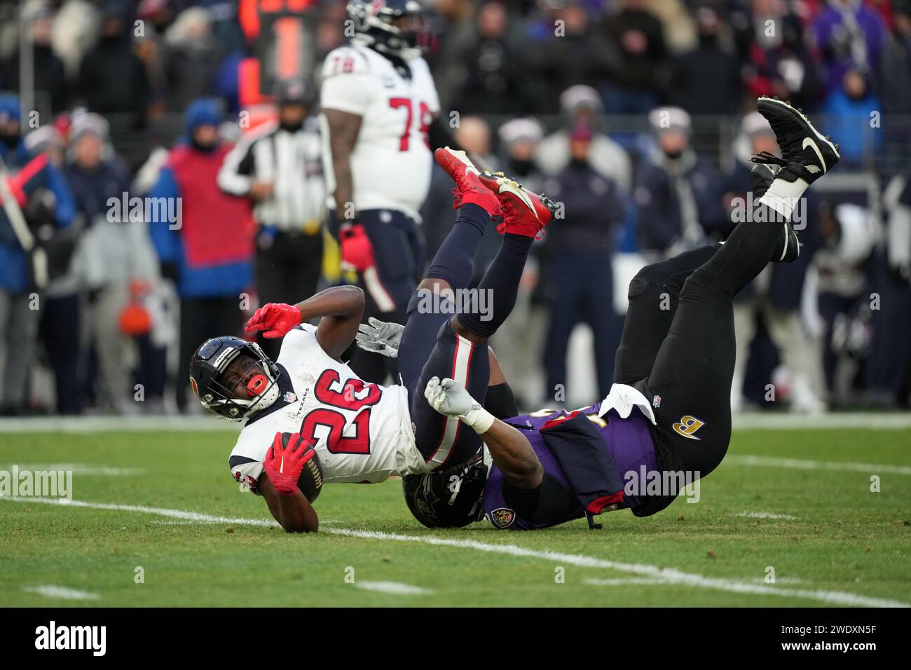 BALTIMORE, MARYLAND, JAN 20: Baltimore Ravens defensive tackle Justin Madubuike (92) tackles Houston Texans running back Devin Singletary (26) in the first half in the AFC Divisional Playoff game at M&T Bank Stadium on January 20, 2024 in Baltimore, Maryland. The Ravens defeated the Texans 34-10. Stock Photo