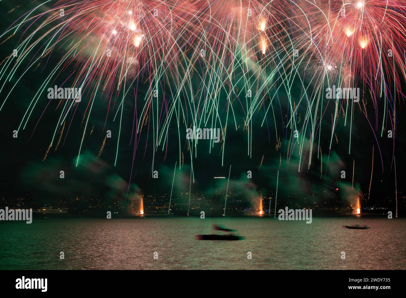 Fireworks over the Lake Zurich at the beginning of new year 2024 in Zurich, Switzerland. Stock Photo