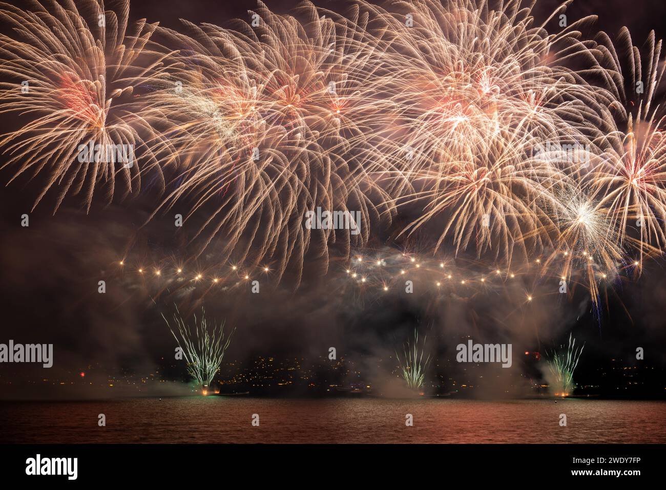 Fireworks over the Lake Zurich at the beginning of new year 2024 in Zurich, Switzerland. Stock Photo