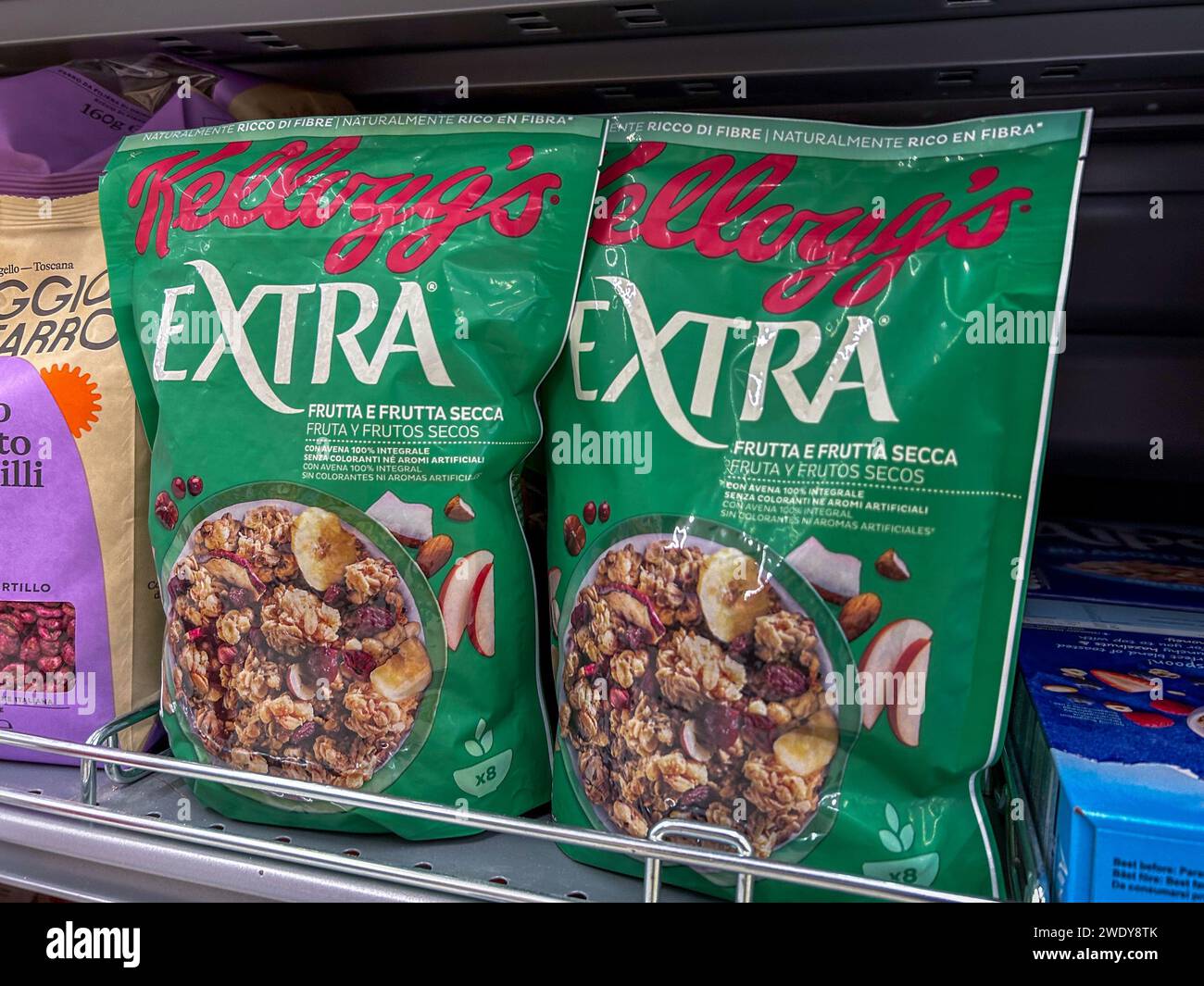 Italy - January 17, 2024: Boxes of Kelloggs Extra Flakes oats with dried fruit displayed for sale in an Italian supermarket Stock Photo