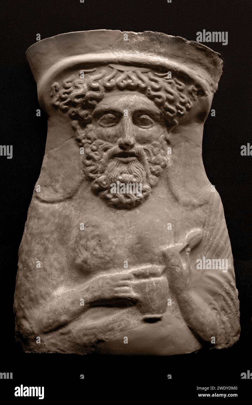 Benaki MuseumThis terracotta bust of the Greek God Dionysos dates to 380-360 BC. He is wearing a stephane (a type of metal upturned hairband) in his hair and is holding an egg in his left hand, and wine jug on his right.  Athens Greece. Stock Photo