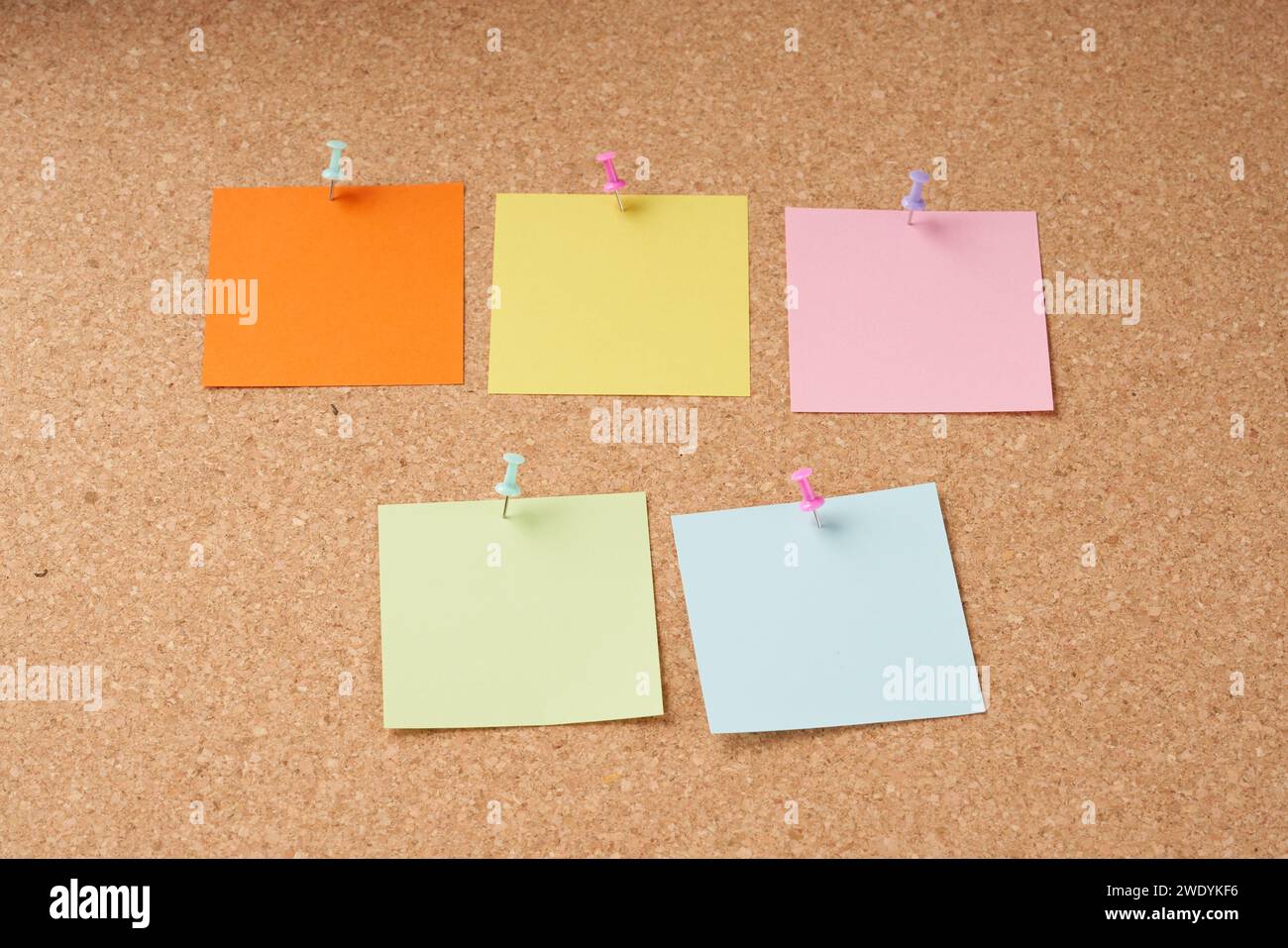 Several multi-colored sheets paper fastened with a paper clip. Stock Photo