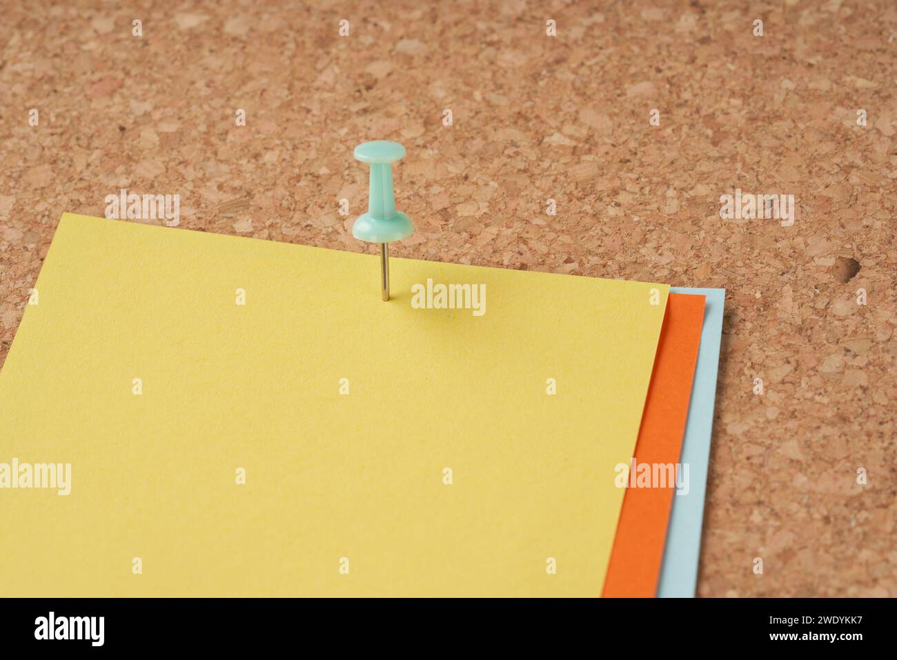Several multi-colored sheets paper fastened with a paper clip. Stock Photo