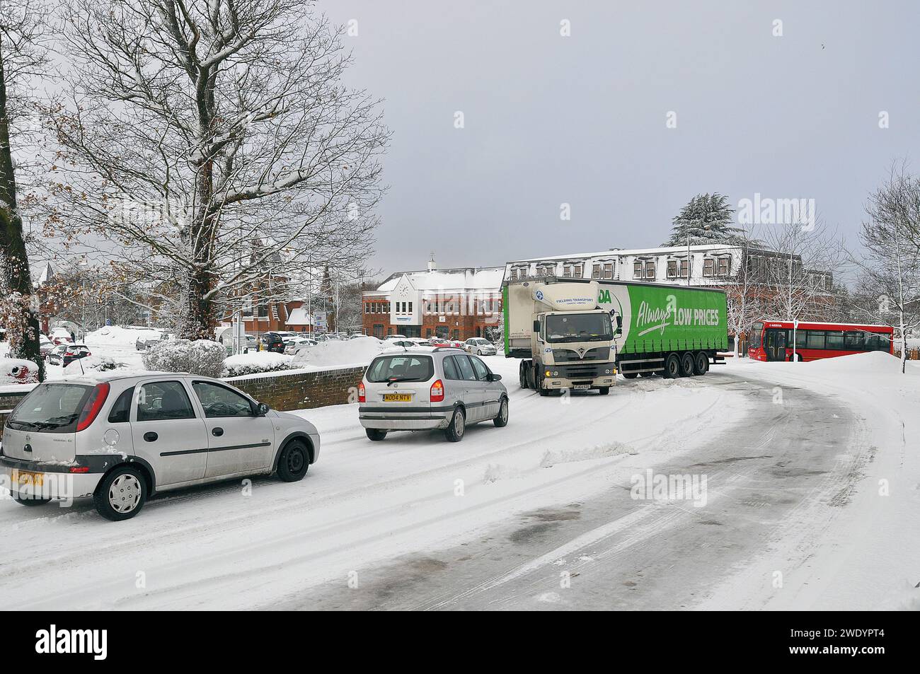 Articulated Asda HGV lorry stuck on snow covered road blocking traffic from multiple directions in Swanley, Kent, UK. Gridlock in town. Travel delays Stock Photo