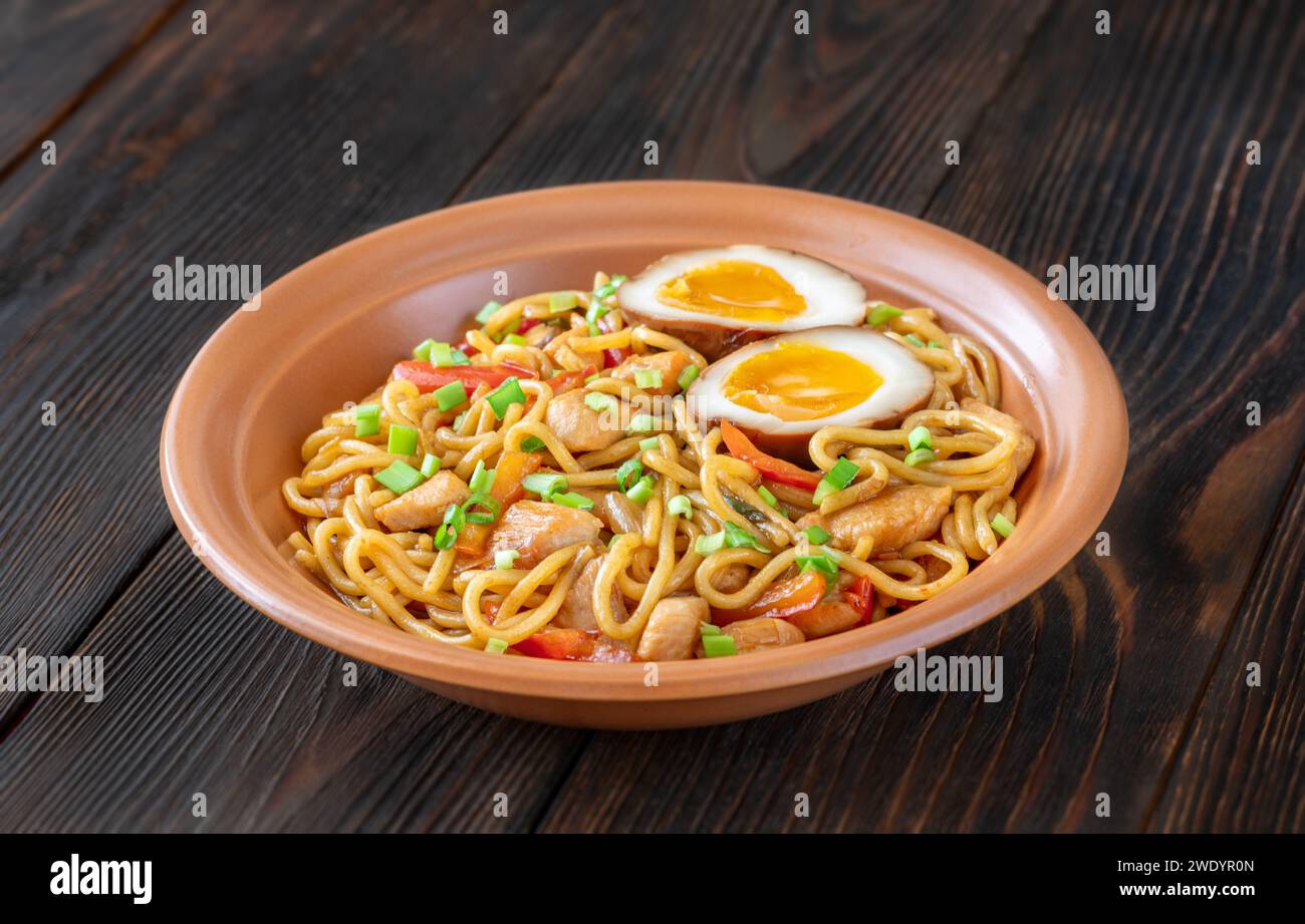 Bowl of Chicken Ramen Noodles garnished with spring onion Stock Photo