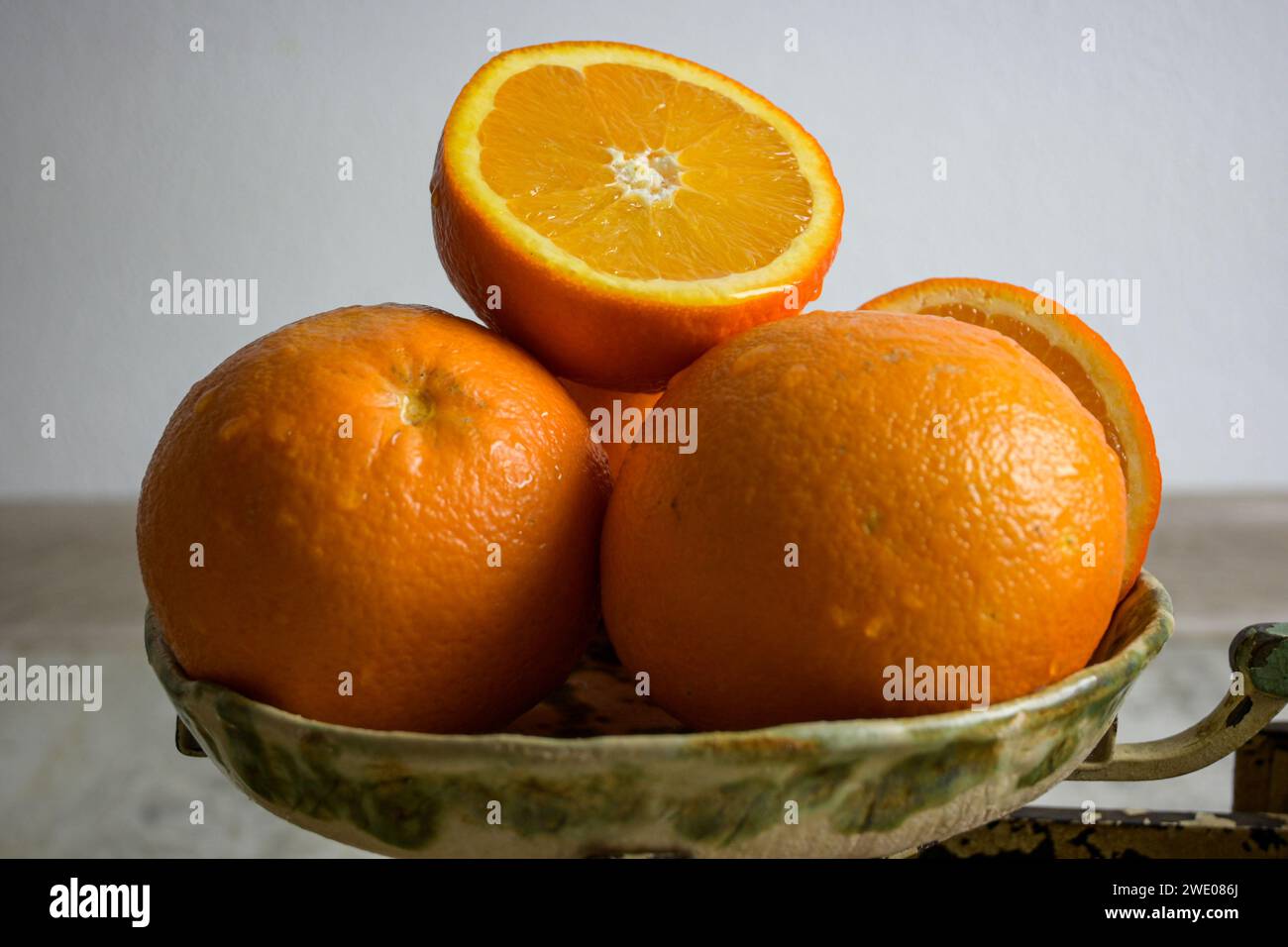fresh oranges on the scale. top view and on white background, retro style. Stock Photo