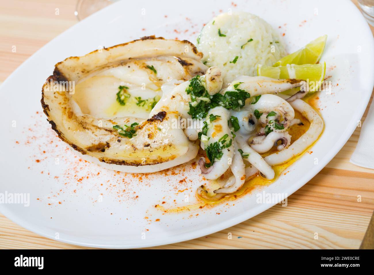 Fried cuttlefish served with rice Stock Photo - Alamy
