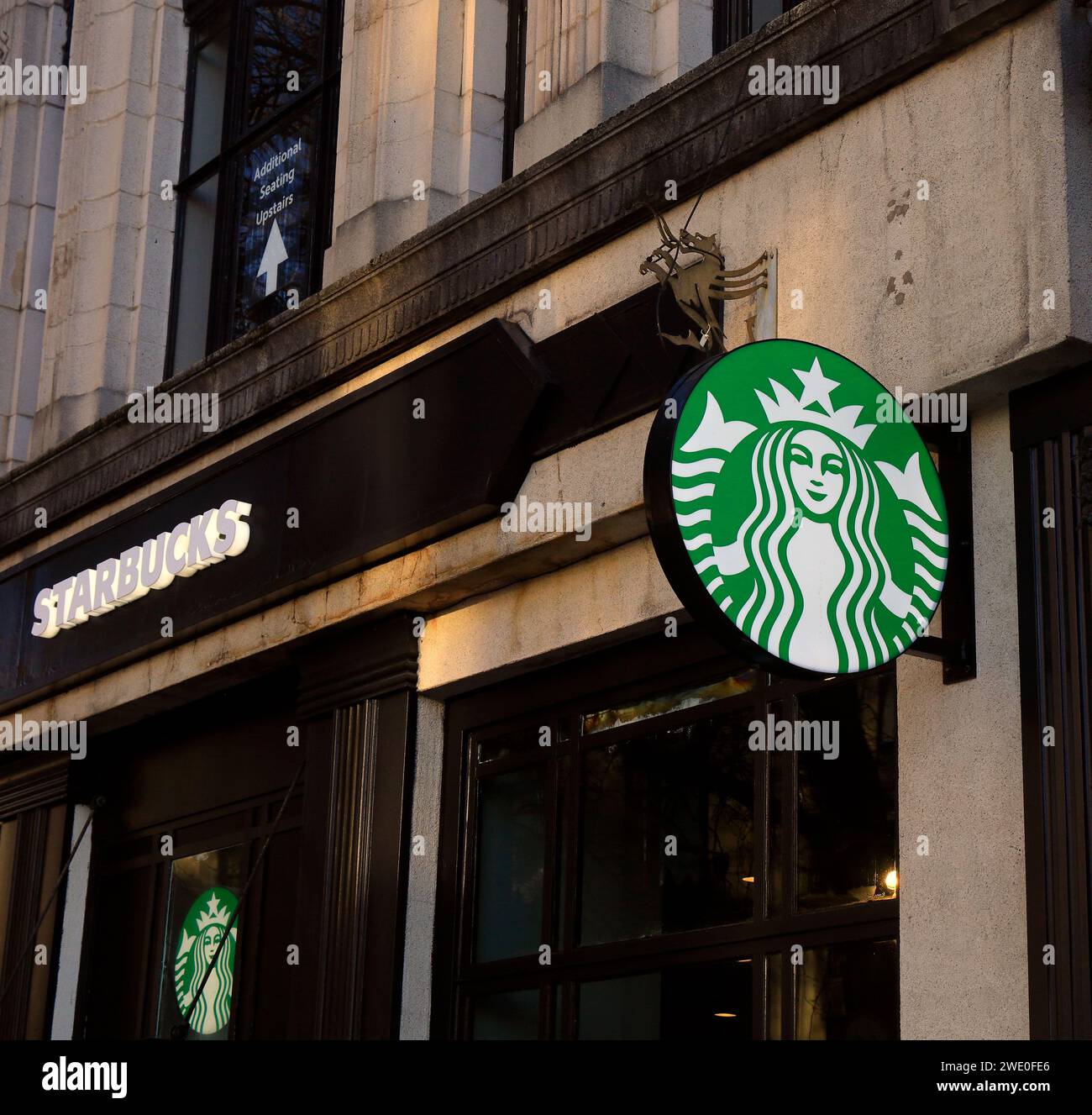 Starbucks coffee shop frontage, logo and rondel sign, Queen Street, Cardiff city centre. Taken