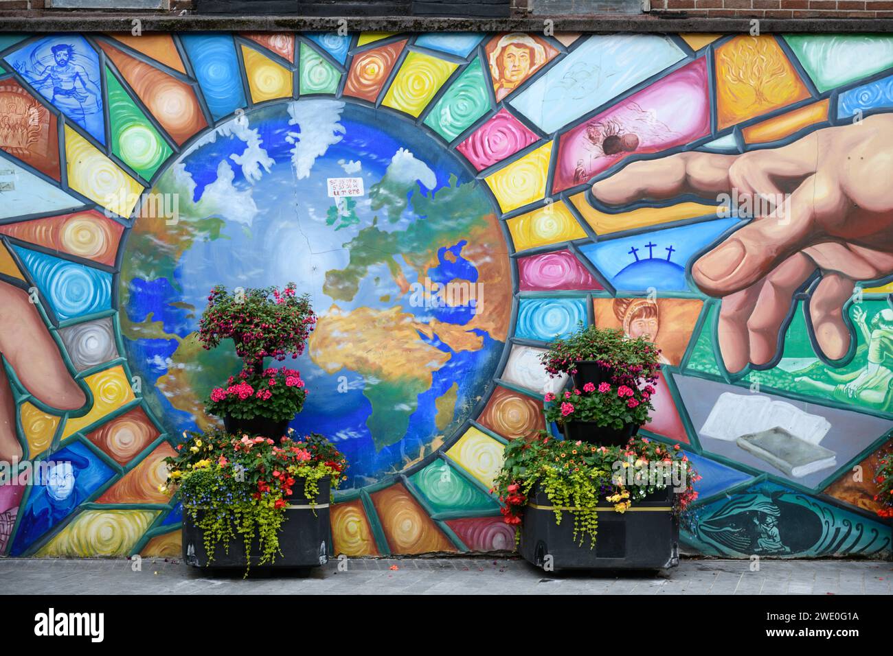 Peace and unity mural painted on the wall of a city square in Belfast, Northern Ireland. Stock Photo