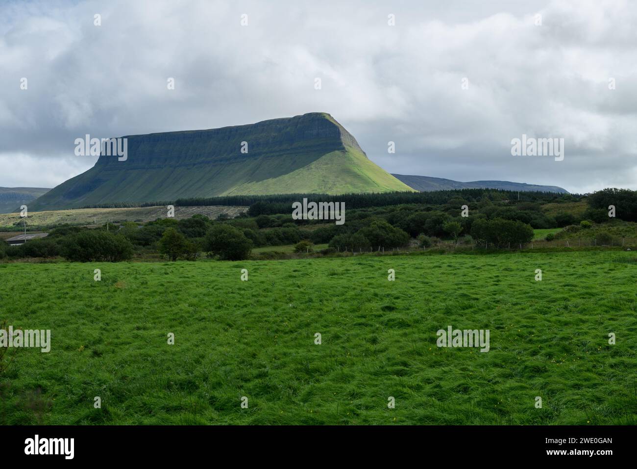 Typical natural landscape of the interior of Ireland on a day with clouds and green mountain in the background Stock Photo