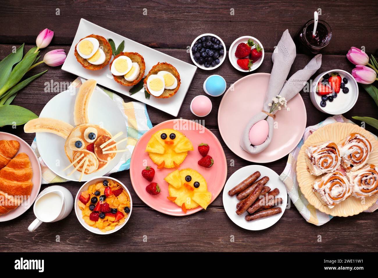 Fun Easter breakfast or brunch table scene. Overhead view on a dark ...