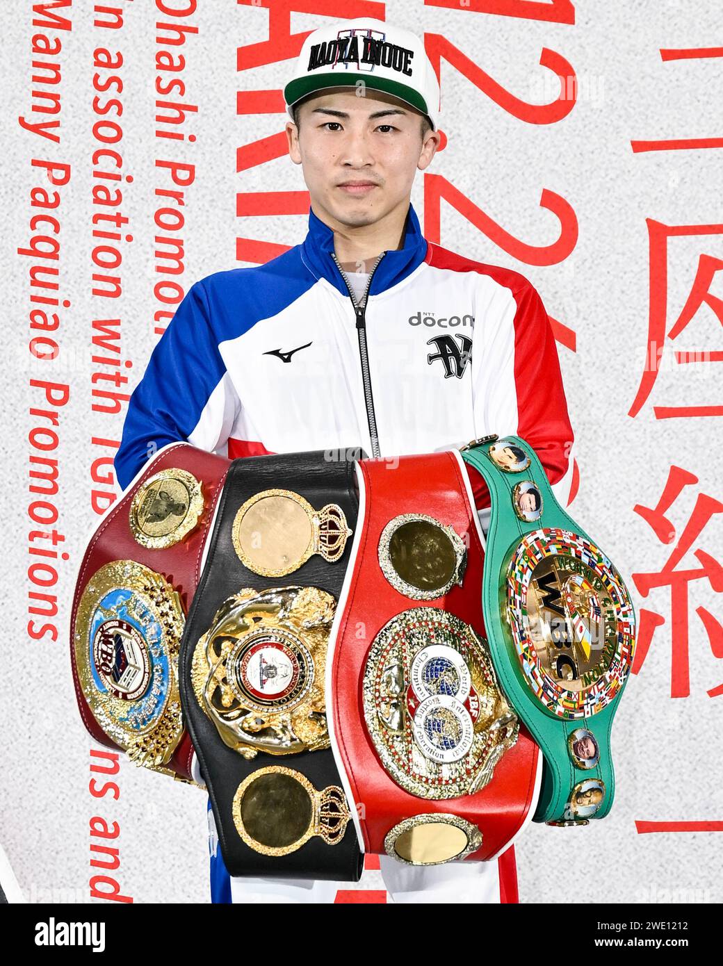 Japan's Naoya Inoue poses with his four champion belts after