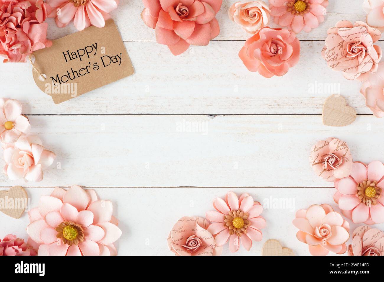 Happy Mothers Day frame with pink paper flowers and gift tag. Top view ...