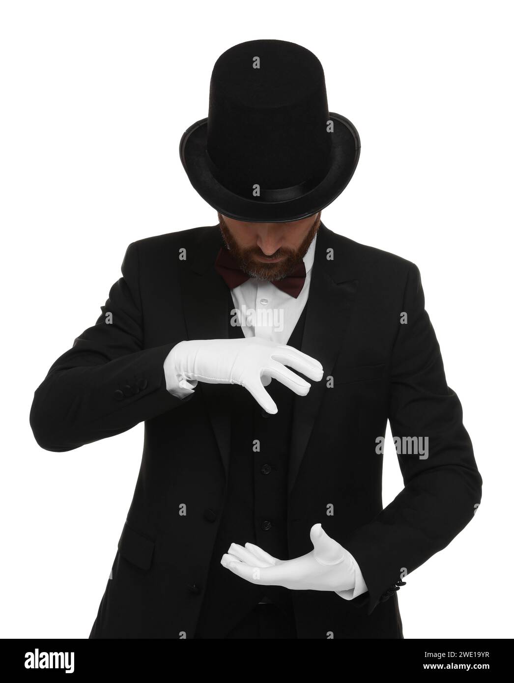 Magician in top hat holding something on white background Stock Photo ...