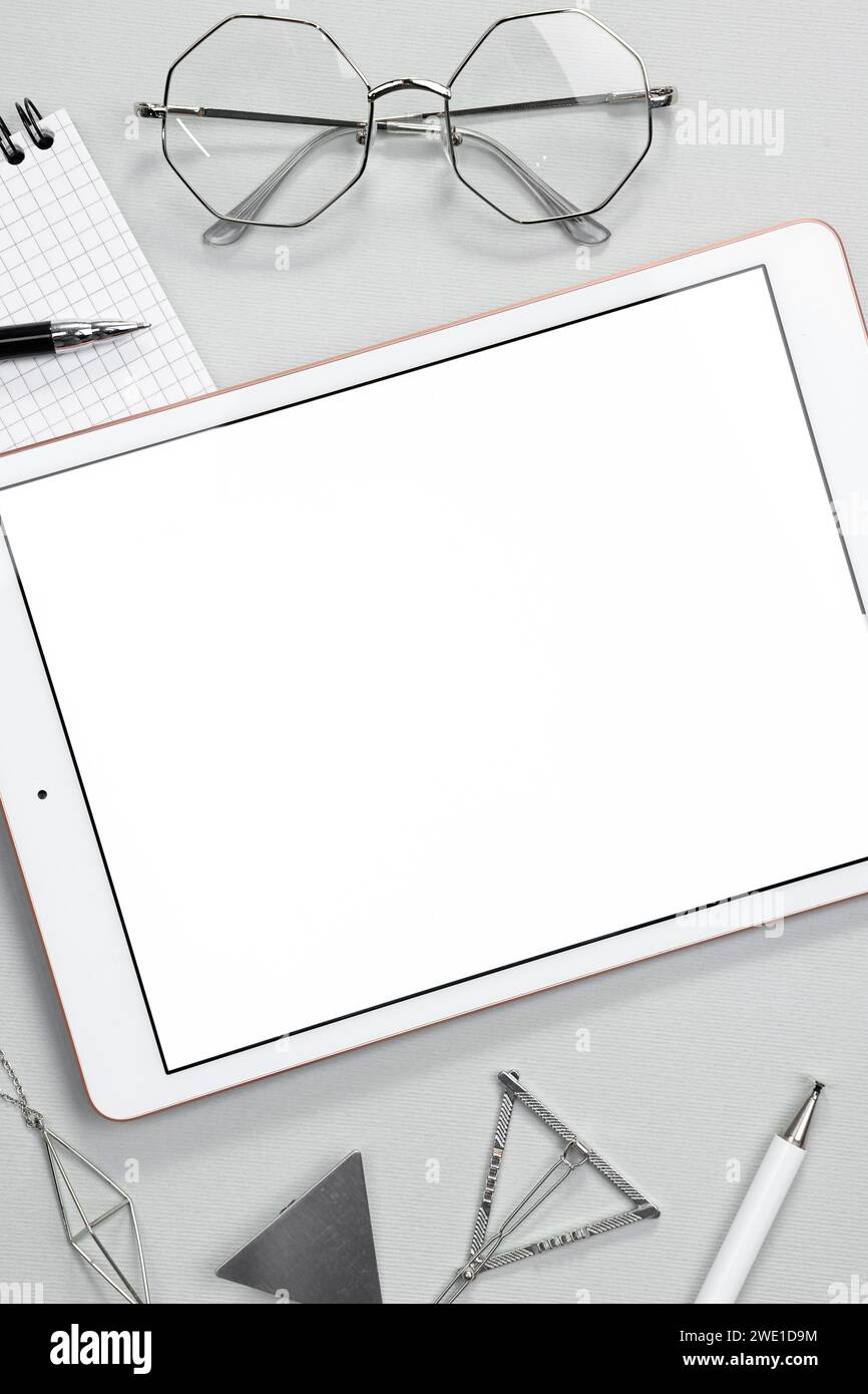 Flat lay composition with modern tablet on light grey background. Space ...