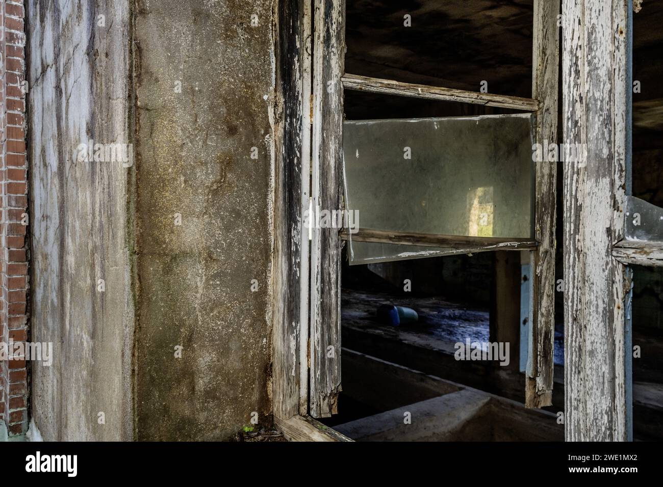 An old, rickety window of an old, abandoned building Stock Photo