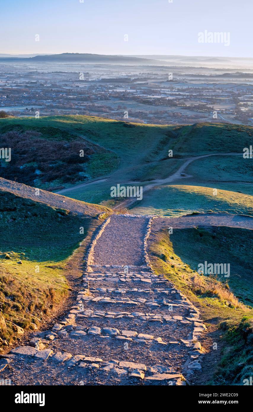Winter sunrise light over the British Camp Hill Fort steps along the Malvern hills, Worcestershire, England Stock Photo
