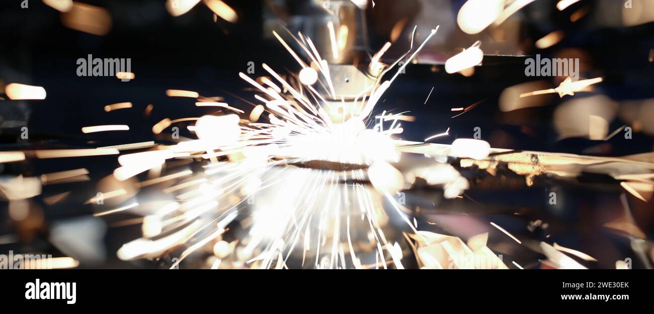 Sparks fly out machine head for metal processing Stock Photo