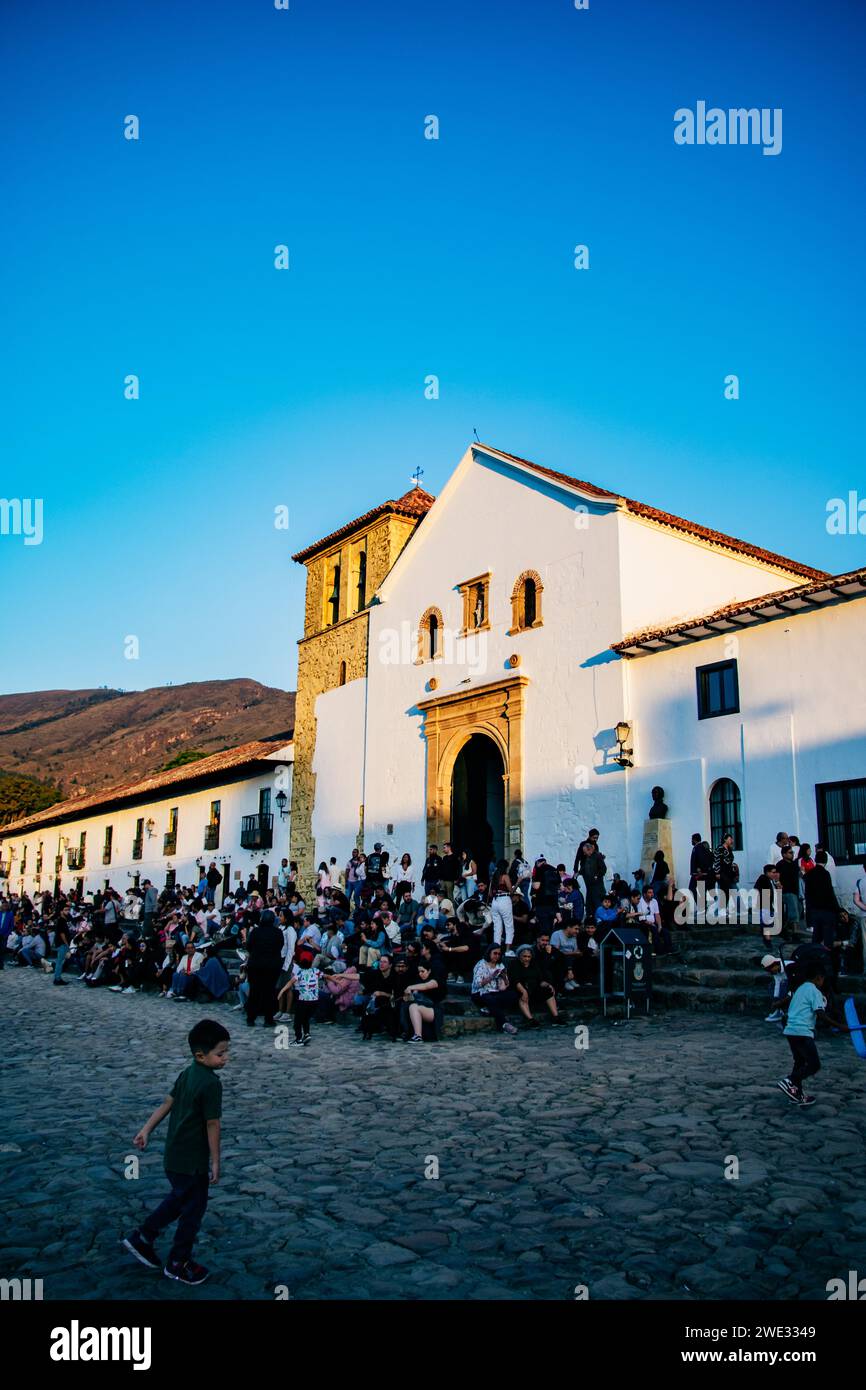 A group of people gathered in the main square of the colonial town of Villa de Leyva, Bogota Stock Photo