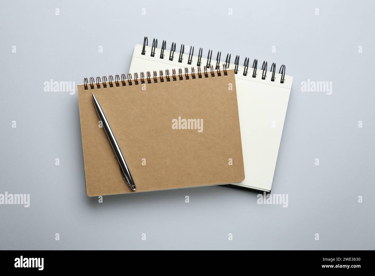 Notebooks on light grey background, top view Stock Photo