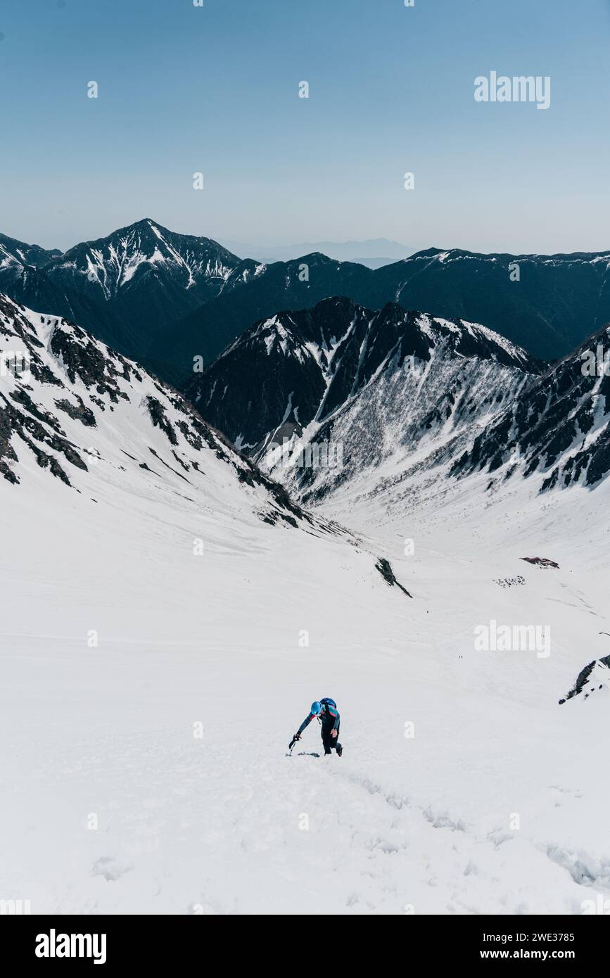 A man ascending a snow mountain in Nagano, Japan Stock Photo