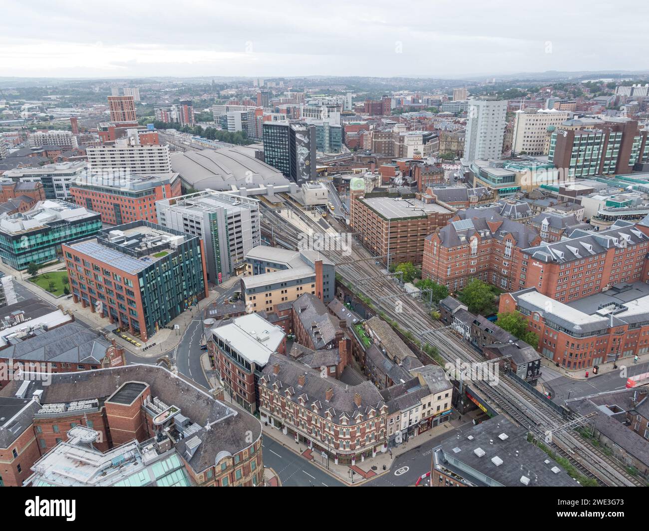 Aerial photograph of Leeds Station train station, platforms and train tracks including the Leeds city centre, Yorkshire, UK Stock Photo
