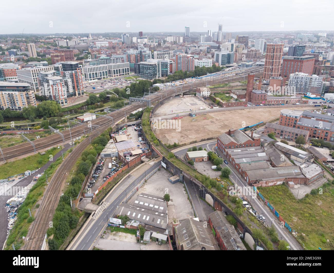 Aerial image of the main trainline and branch into Leeds, Yorkshire, UK with Holbeck Viaduct, Whitehall, Globe Point site, Mustard Wharf & city centre Stock Photo