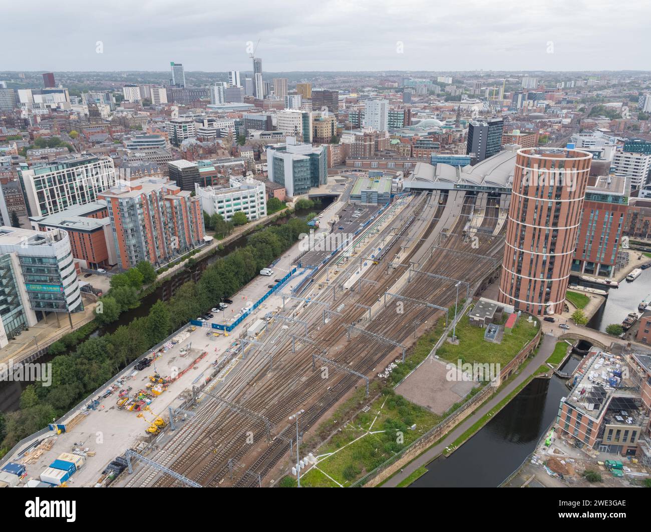 Aerial photograph of Leeds train station with platforms, roof, trains, tracks, Candle House and the wider Leeds city centre, Yorkshire, UK Stock Photo