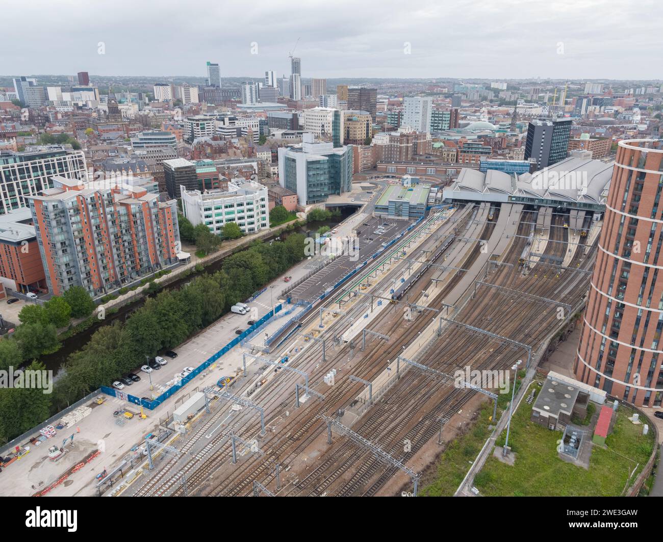 Aerial photograph of Leeds train station with platforms, roof, trains, tracks, Candle House and the wider Leeds city centre, Yorkshire, UK Stock Photo
