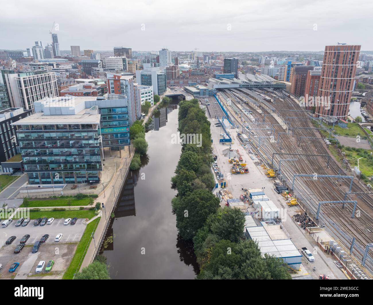 Aerial image looking down River Aire towards Leeds city centre, UK including 1 Whitehall Riverside, trainline to Leeds Station & Leeds Liverpool Canal Stock Photo