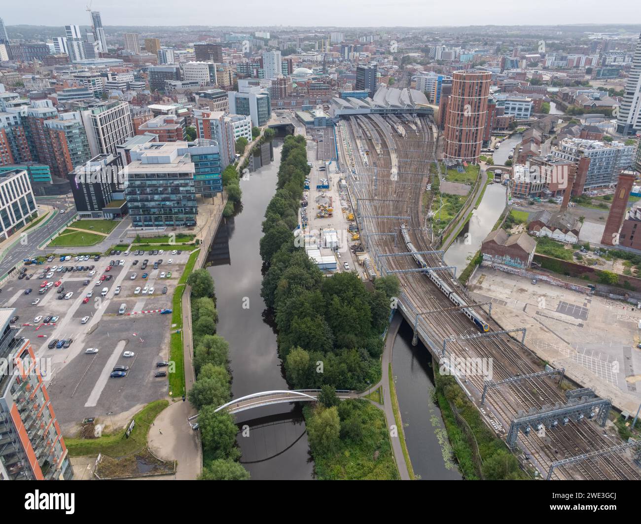 Aerial image looking down River Aire towards Leeds city centre, UK including 1 Whitehall Riverside, trainline to Leeds Station & Leeds Liverpool Canal Stock Photo