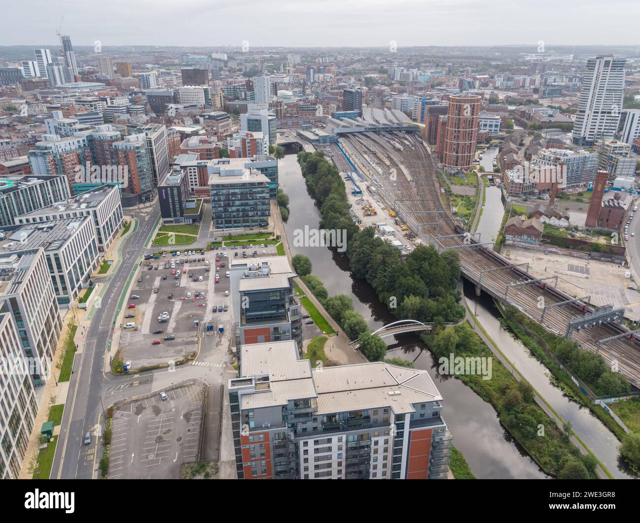 Aerial image looking down River Aire towards Leeds city centre, UK including 1 Whitehall Riverside, trainline to Leeds Station & Leeds Liverpool Canal Stock Photo