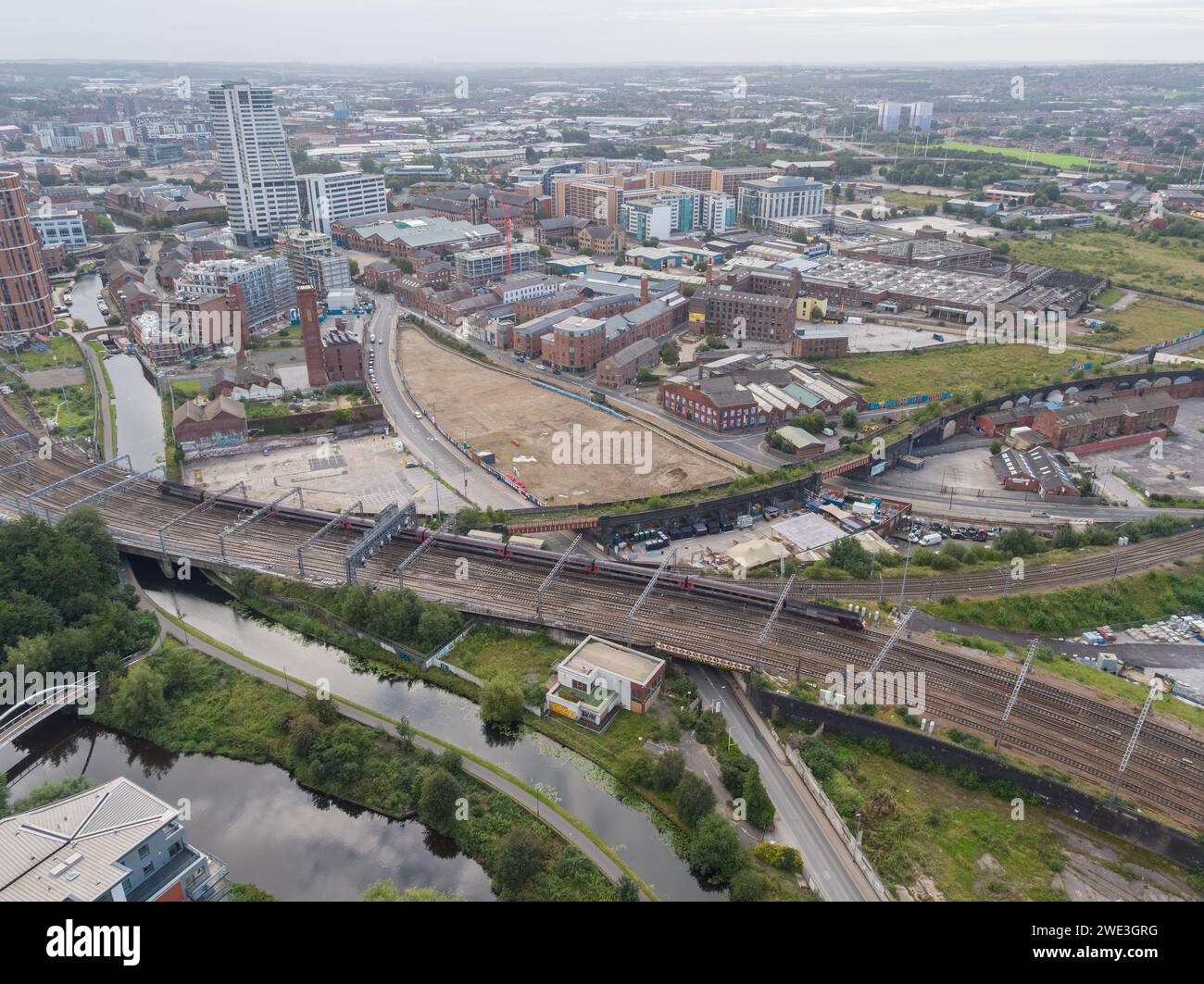 Aerial photograph of the main train line into Leeds Station, UK, River Aire, Leeds Liverpool Canal and roads with Globe Point site before construction Stock Photo