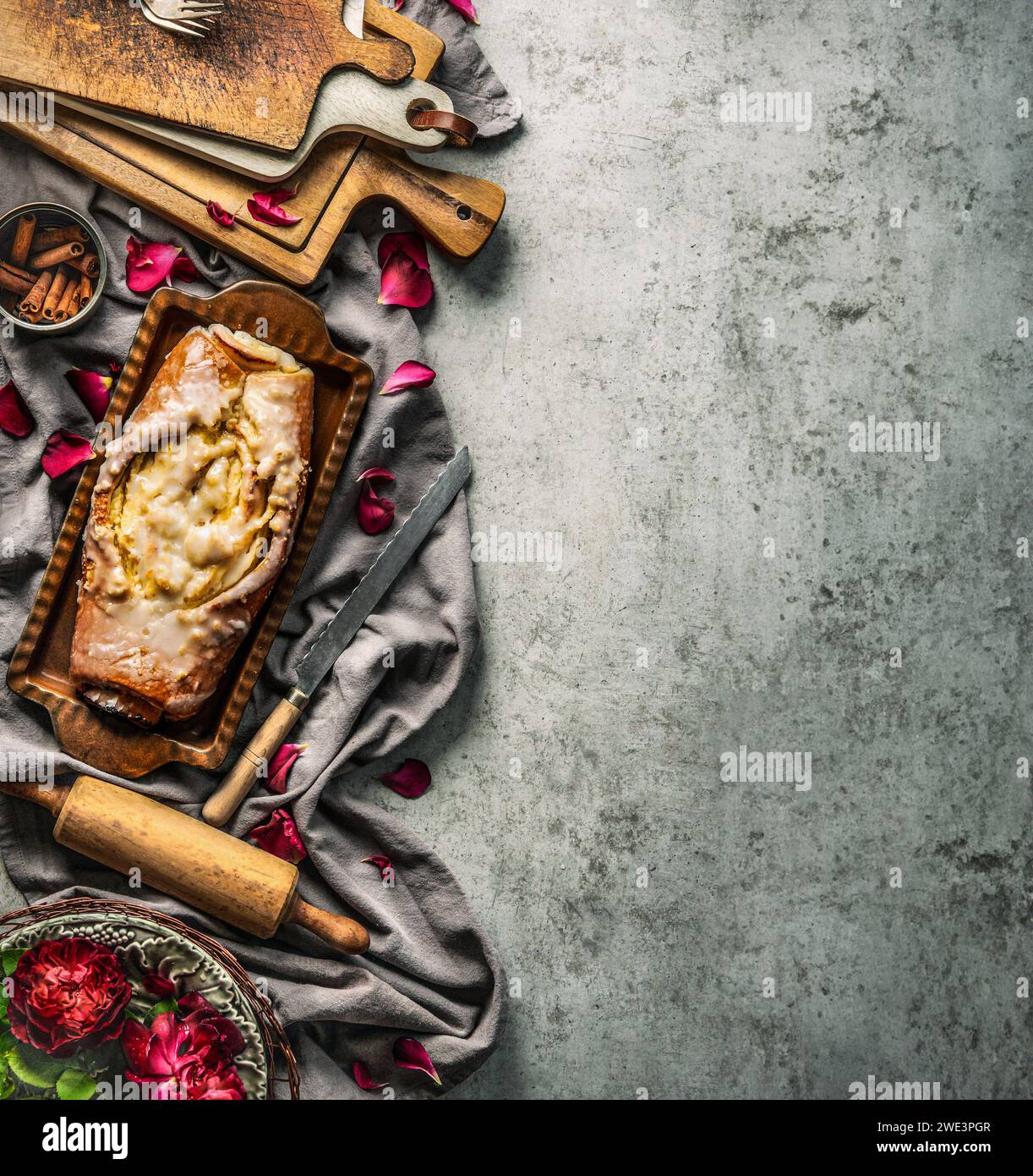 Baking background with cake, flowers and vintage kitchen bake utensils on rustic background, top view with copy space Stock Photo