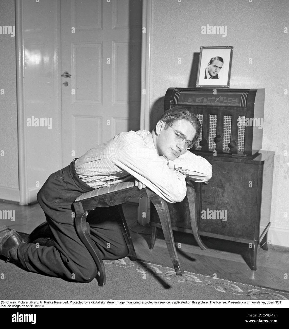 Radio listener in the 1940s. A man listens to the radio broadcast from