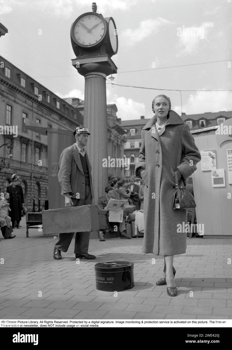 Fashionable in the 1950s. A young woman wears a typical 1950s coat. A