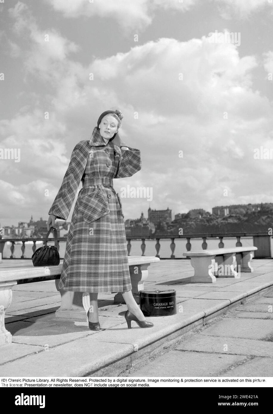 Fashionable in the 1950s. A young woman wears a typical 1950s coat. A