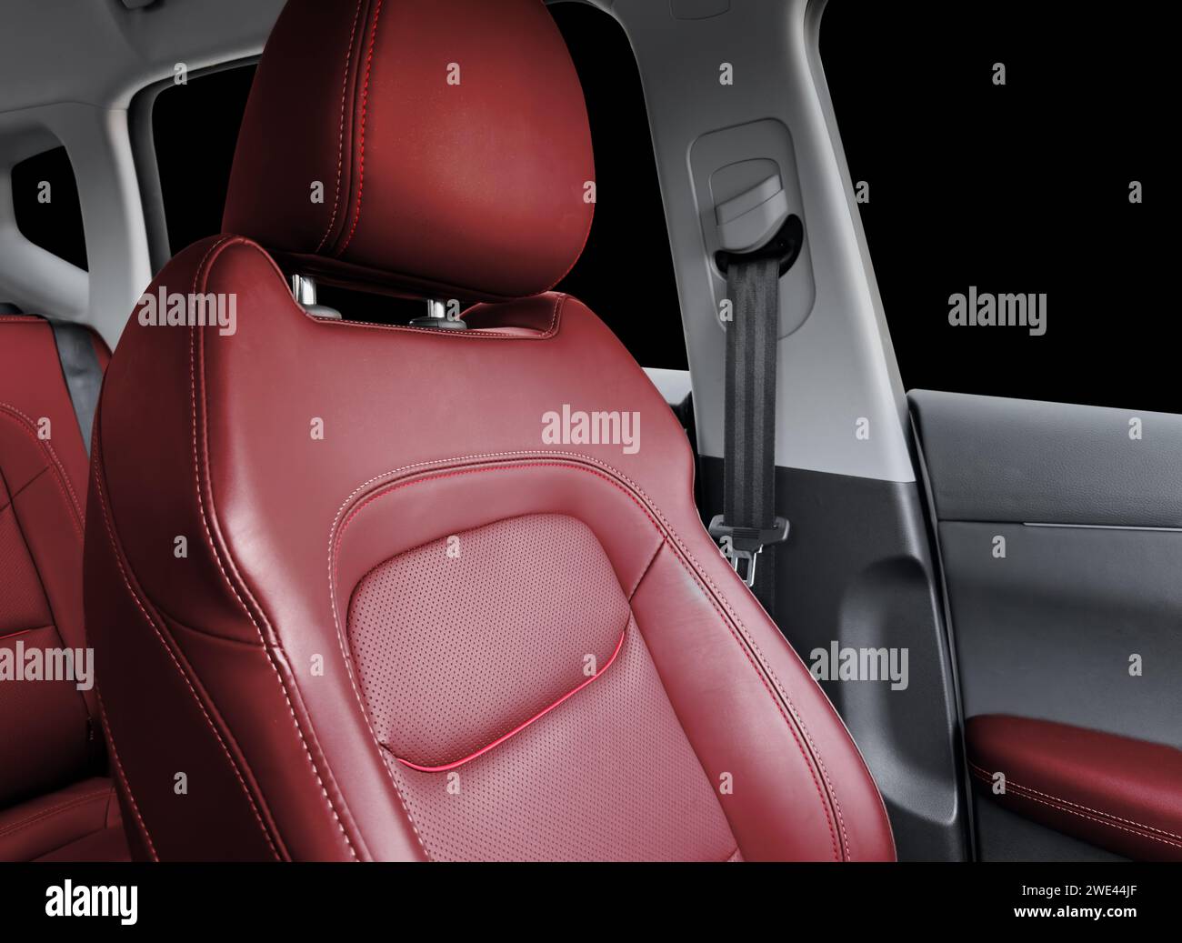 Red luxury modern car Interior. Detail of modern car interior. Part of red leather seats with red stitching in expensive car Stock Photo