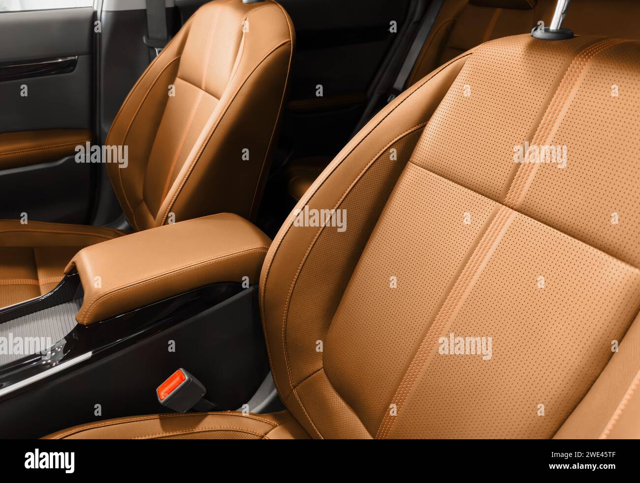 Brown luxury modern car Interior. Detail of modern car interior. Part of brown leather seats with red stitching in expensive car Stock Photo