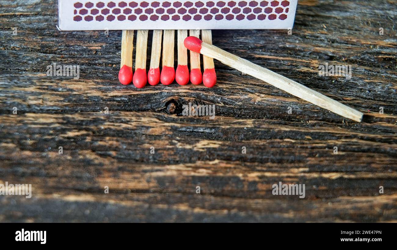 Matches sticks with red head on rustic wooden table Stock Photo