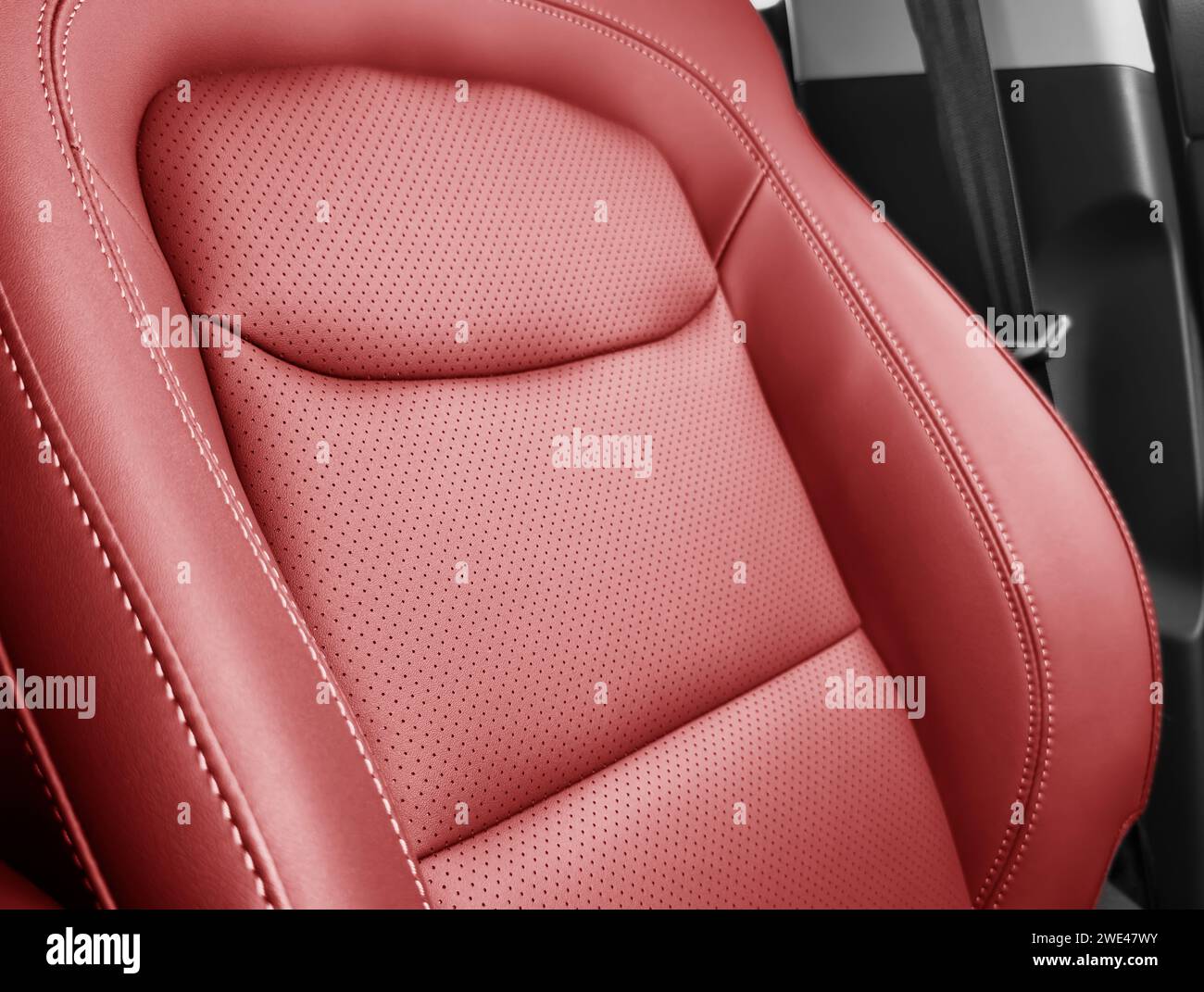 Red luxury modern car Interior. Detail of modern car interior. Part of red leather seats with stitching in expensive car Stock Photo