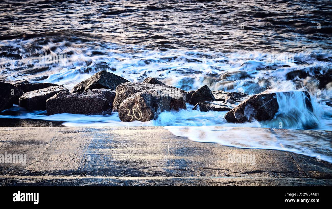 Waves breaking on rocks on the coast Stock Photo