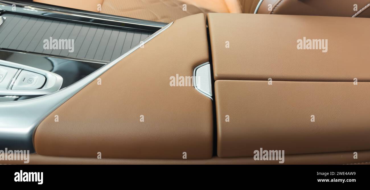 Brown luxury modern car Interior. Detail of modern car interior. Part of brown leather seats with red stitching in expensive car Stock Photo