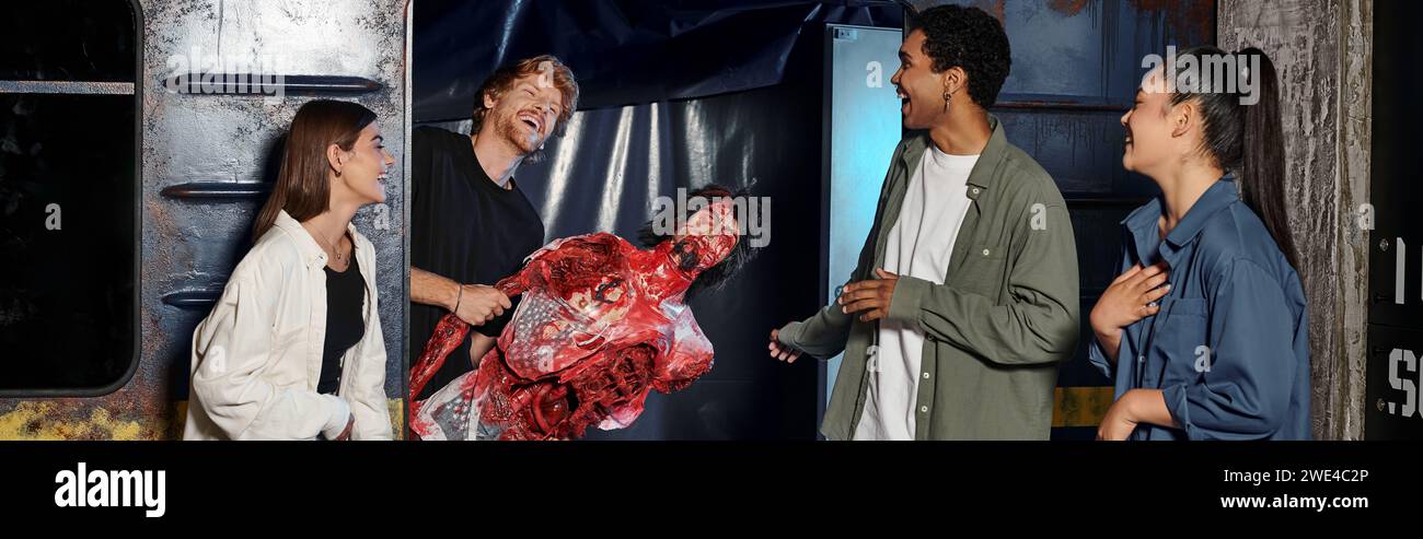 Cheerful Young Man Holding Creepy Mannequin And Scaring Multicultural