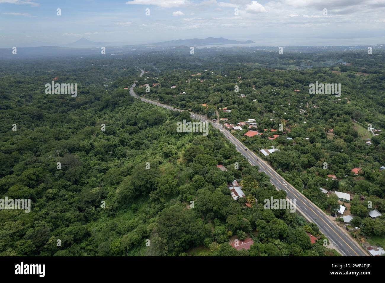 Highway road to Managua Nicaragua aerial drone view  with volcano and lake background Stock Photo