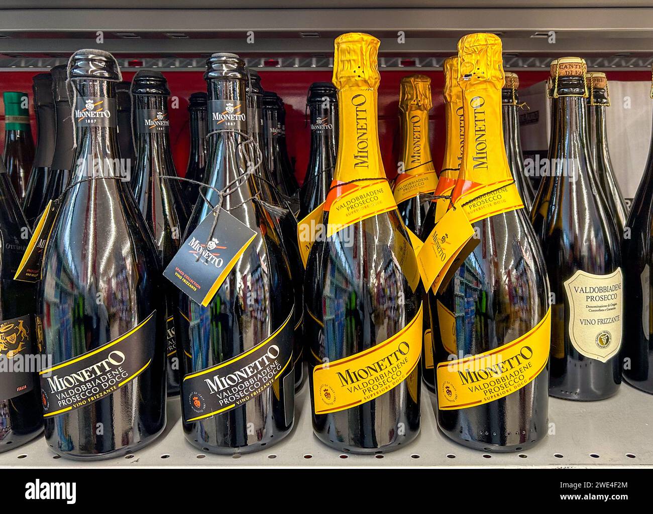 Italy - January 17, 2024: Valdobbiadene Prosecco DOCG sparkling wine in Mionetto brand bottles displayed on shelf for sale in Italian supermarket Stock Photo