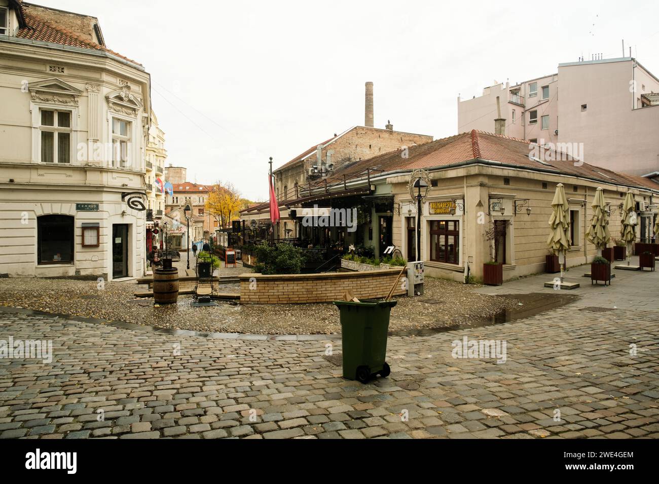 Belgrade, Serbia - December 2, 2023: A daytime photo of Skadarlija neighborhood in Belgrade, Serbia, featuring scattered yellow leaves on the ground, Stock Photo